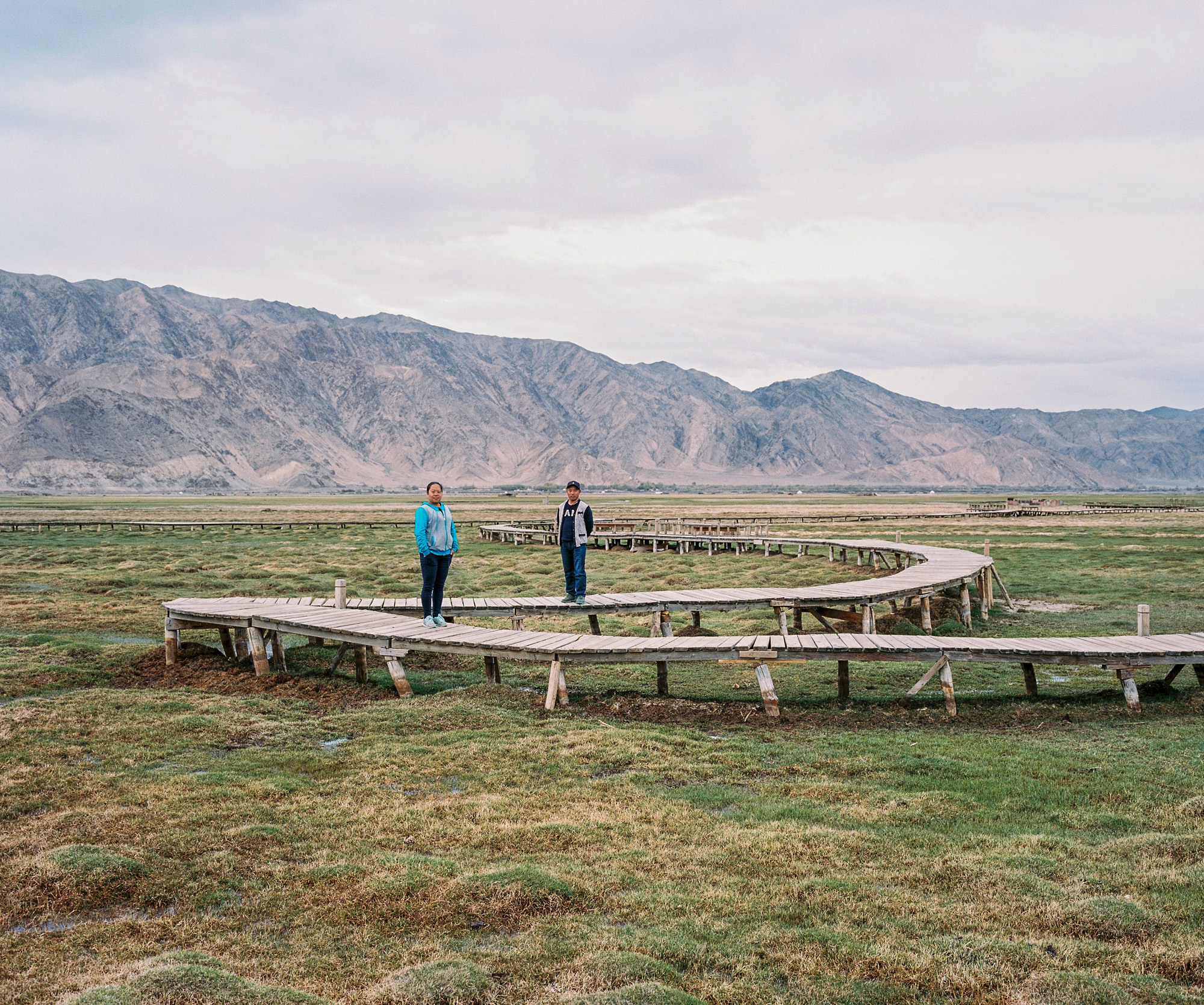 A Han Chinese couple living and working in Tashkurgan posing on the Wetlands in Tashkurgan Tajik Autonomous County in Xinjiang at the border with Tajikistan. He is from Kashgar but they have met in Tashkurgan and now live there. he owns a business.